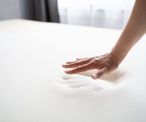 Memory foam conforming to the shape of a person’s hand.